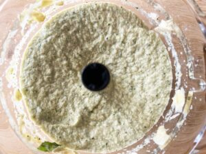 Blended Artichoke Pesto in a food processor. Overhead focus.