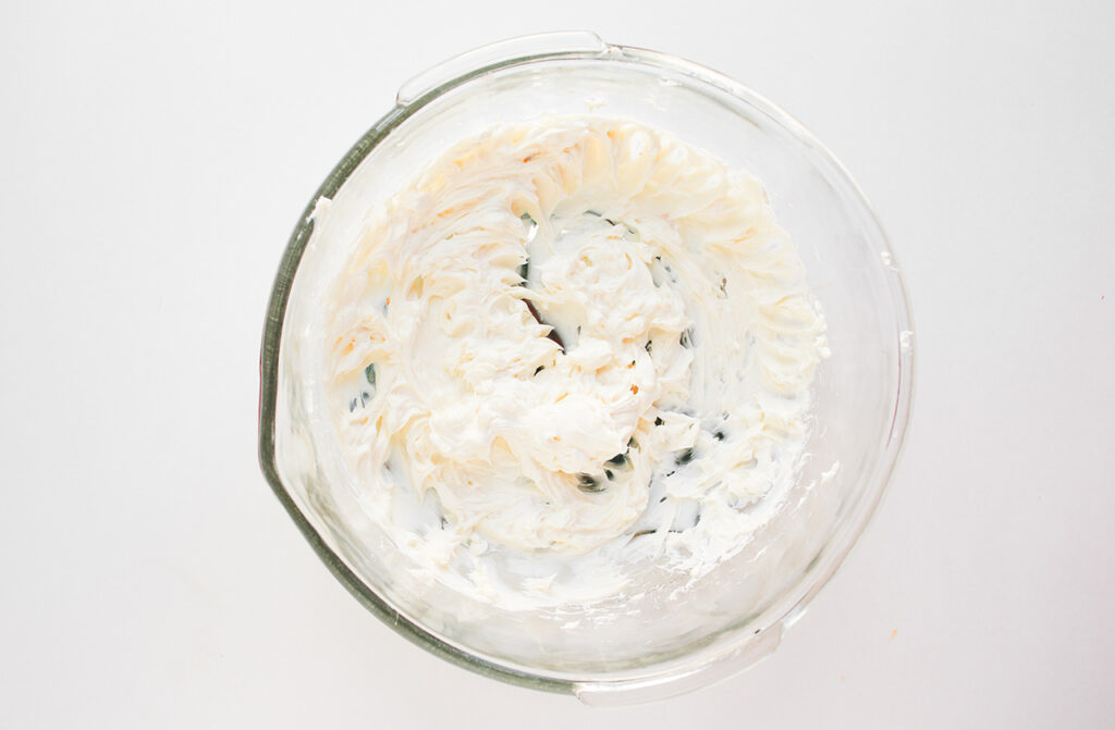 Cream cheese whipped in a glass bowl.