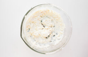 Cream cheese whipped in a glass bowl.