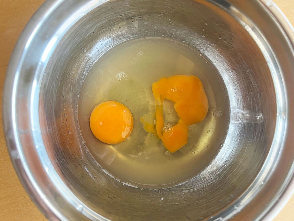 Eggs and lemon juice in a bowl.