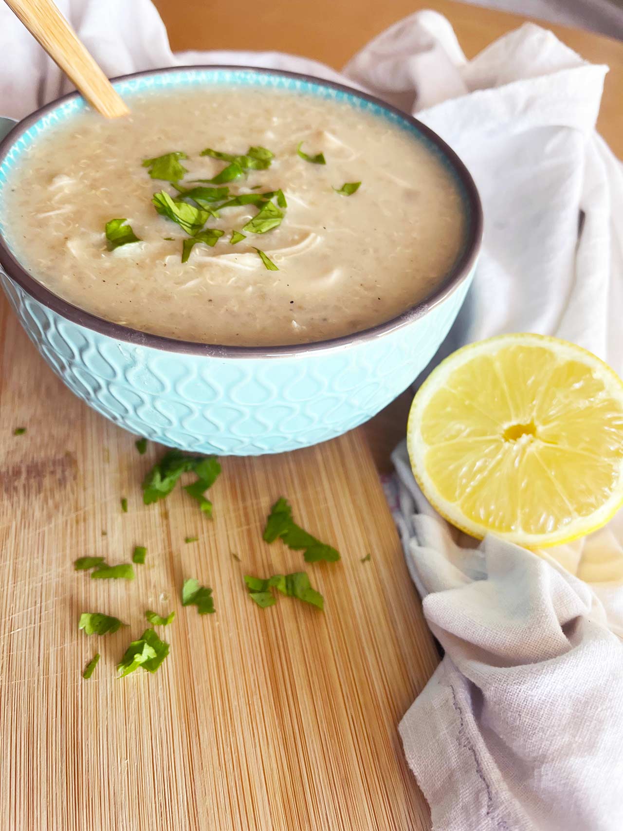 Front view of a mug filled with Greek Avgolemono Soup.