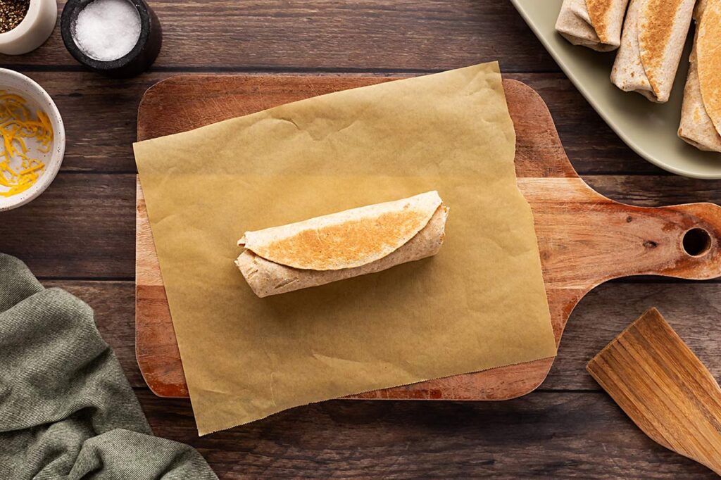 A single Healthy Breakfast Burrito on a piece of parchment.