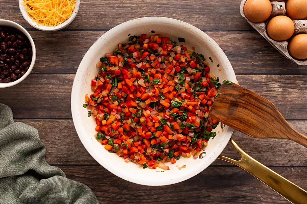 Cooked vegetable scramble in a skillet.