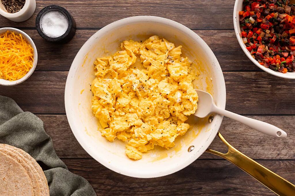 Cooked scrambled eggs in a skillet.