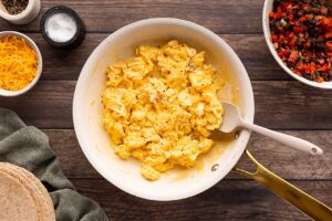Cooked scrambled eggs in a skillet.