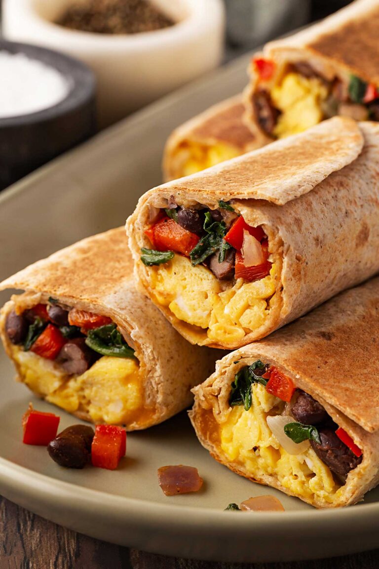 Cut Healthy Breakfast Burritos stacked on a platter.
