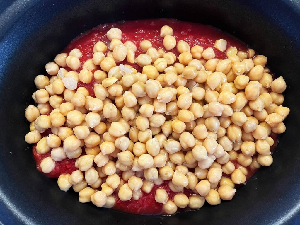 Chickpeas added to a slow cooker crock.