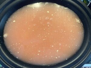 Broth added to a slow cooker crock.