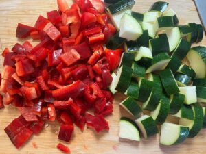 Chopped veggies on a cutting board for Mediterranean Chicken Soup.