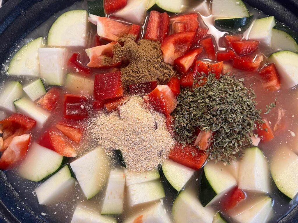 Spices added to a slow cooker crock.