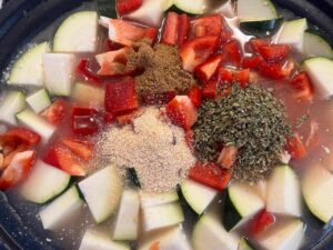 Spices added to a slow cooker crock.