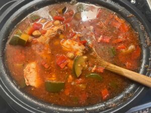 The finished Mediterranean Chicken Soup in a slow cooker crock.