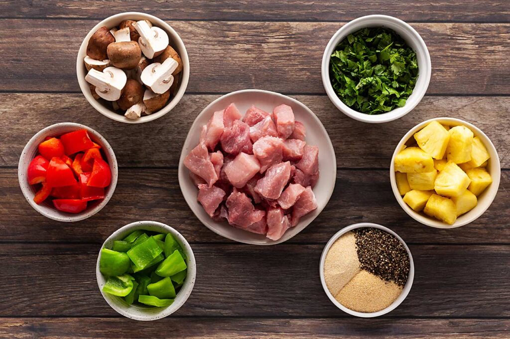 Pork Kabobs ingredients on a wood surface.