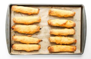 Just-baked Chicken Taquitos cooling on a baking pan.