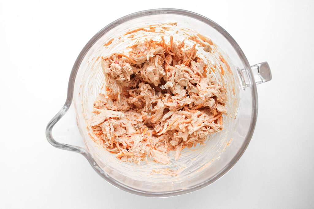 Mixed Chicken Taquito filling in a glass bowl.
