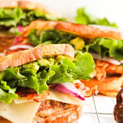 Closeup front view of a Chipotle Chicken Club Sandwich on a wire rack.