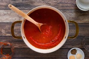 Water added to Enchilada Sauce in a pot.