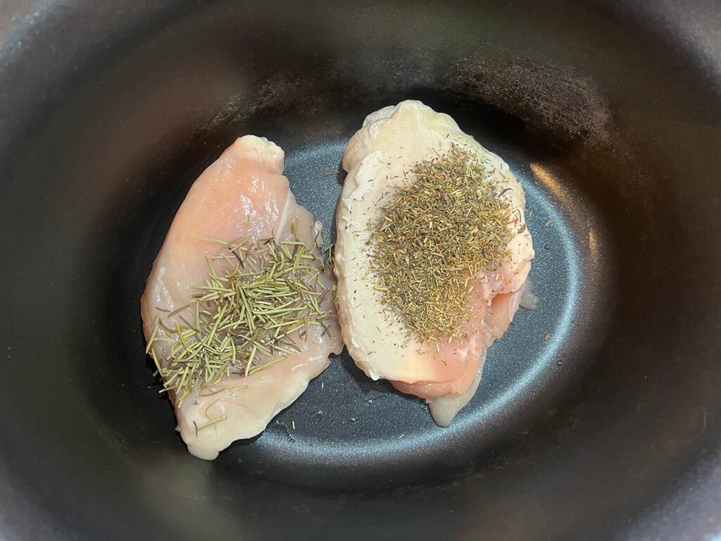 Herbs sprinkled over the chicken.