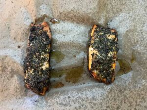 Baked Mediterranean Herb-Crusted Salmon on parchment paper.