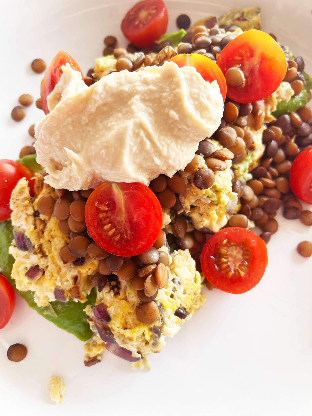 Overhead closeup of a Mediterranean Omelette on a white plate.