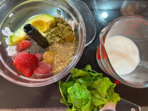 Hemp Protein Smoothie ingredients. Some in a blender tumbler, some in measuring cups.
