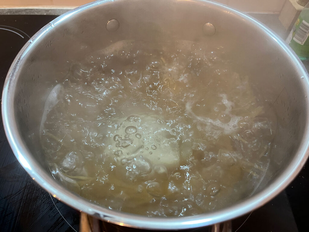 Pasta boiling in water on a stove.