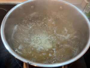 Pasta boiling in water on a stove.
