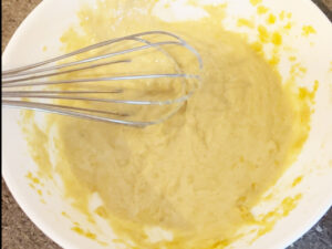 Lemon sauce whisked in a bowl.