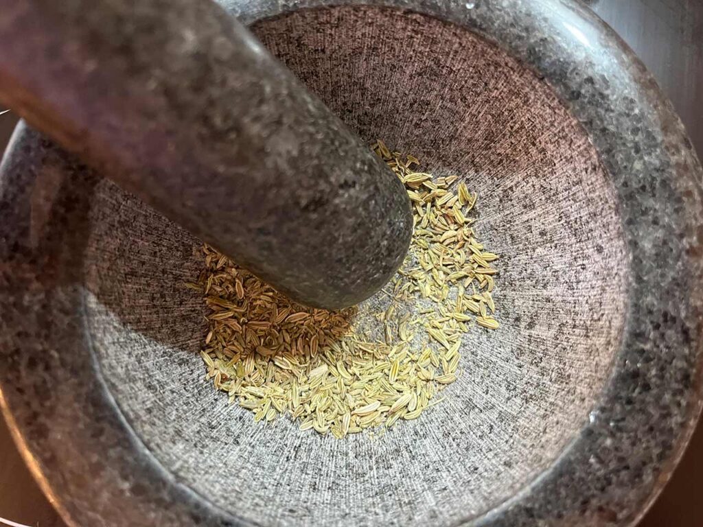 Mashing the fennel seed in this Copycat Trader Joe's Pizza Seasoning.