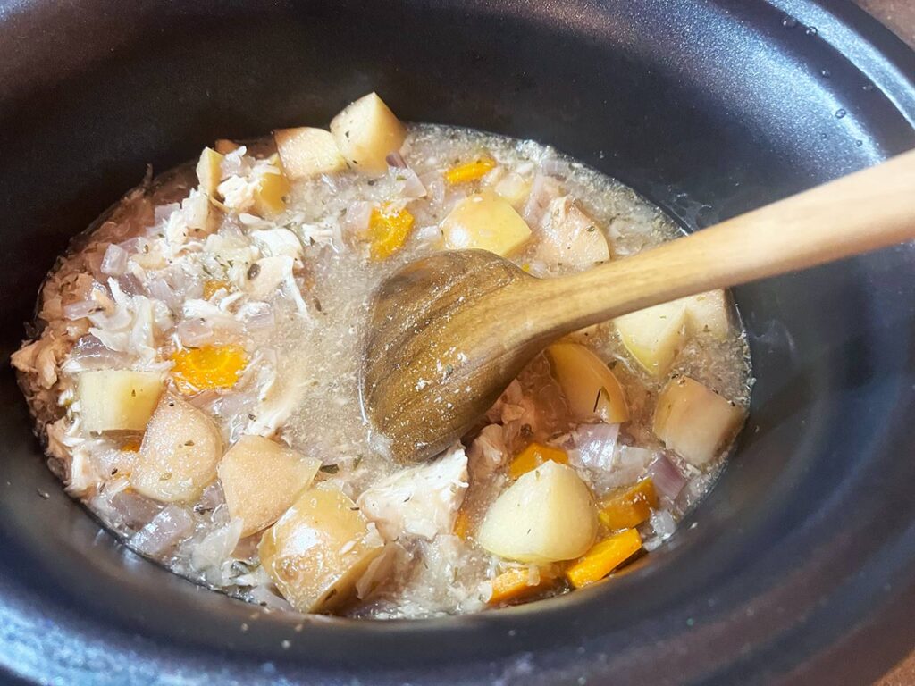 Shredding the chicken after cooking in the slow cooker.