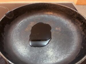 A cast iron skillet with oil in it.