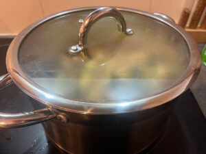 A lid placed on a pot so the ingredients can come to a boil.