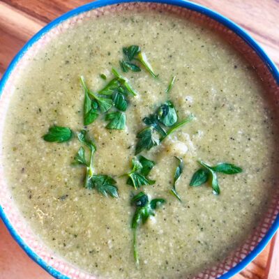 Closeup overhead focus of a mug filled with Creamy Zucchini Soup.