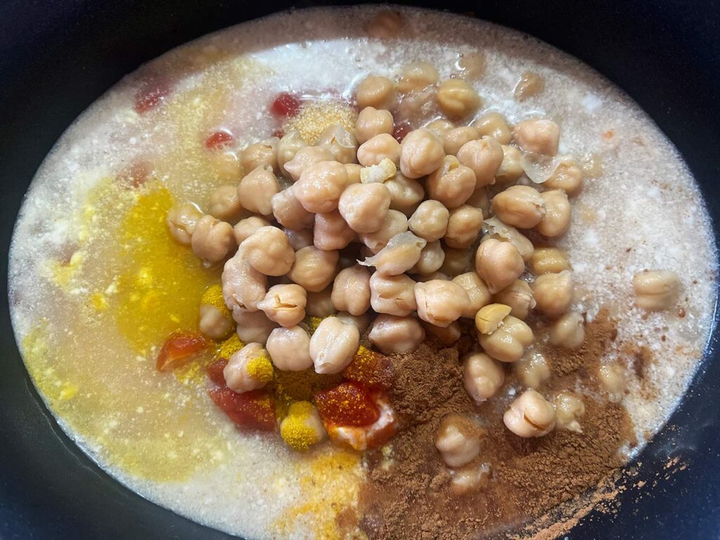 Chickpeas added to a slow cooker crock.
