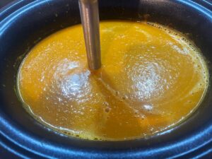 Blending the soup with a stick blender in the slow cooker crock.