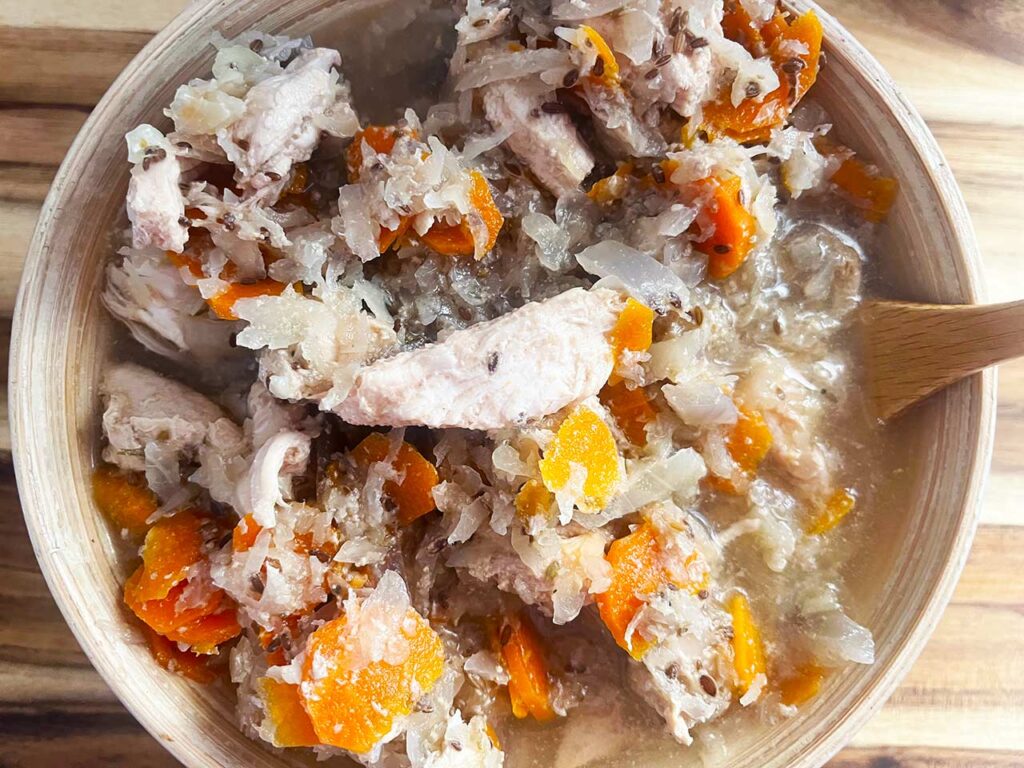 Overhead closeup of a full bowl of Slow Cooker Chicken And Cabbage.