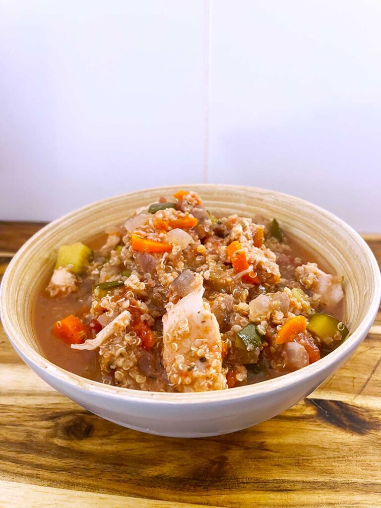 Front angled view. A bowl full of Slow Cooker Chicken And Quinoa Stew.