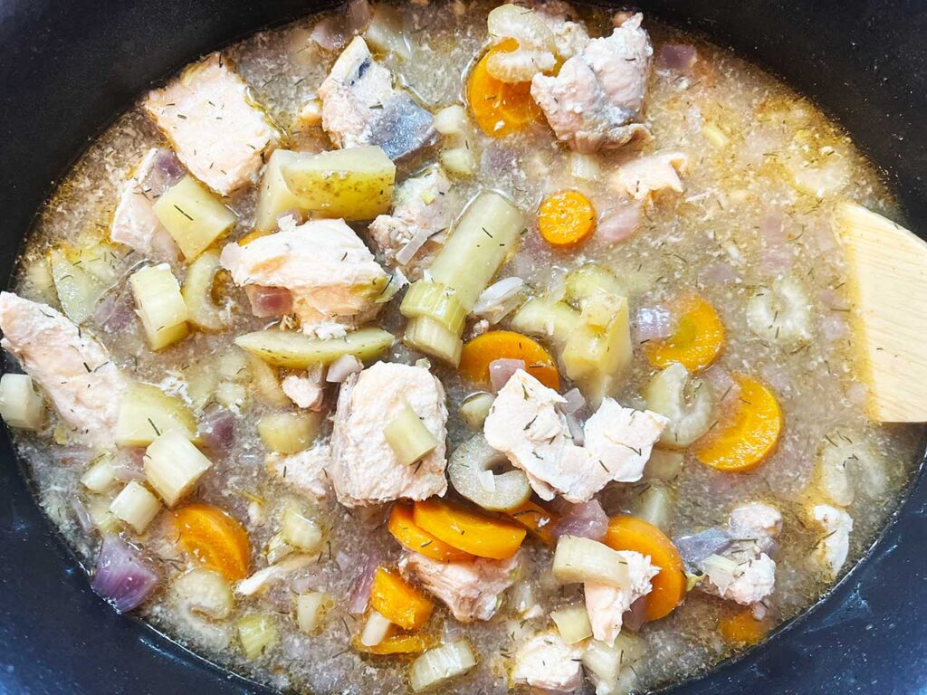 The cooked stew in a slow cooker crock.