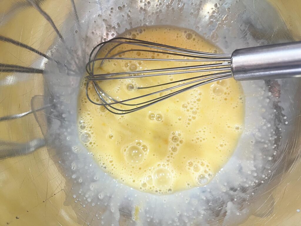 Wet ingredients for apple cookies whisked together in a mixing bowl.
