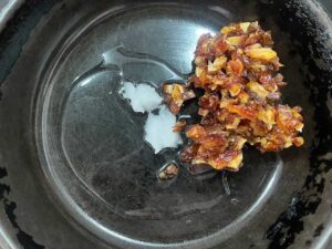 Oil melting in a skillet with chopped dates added.