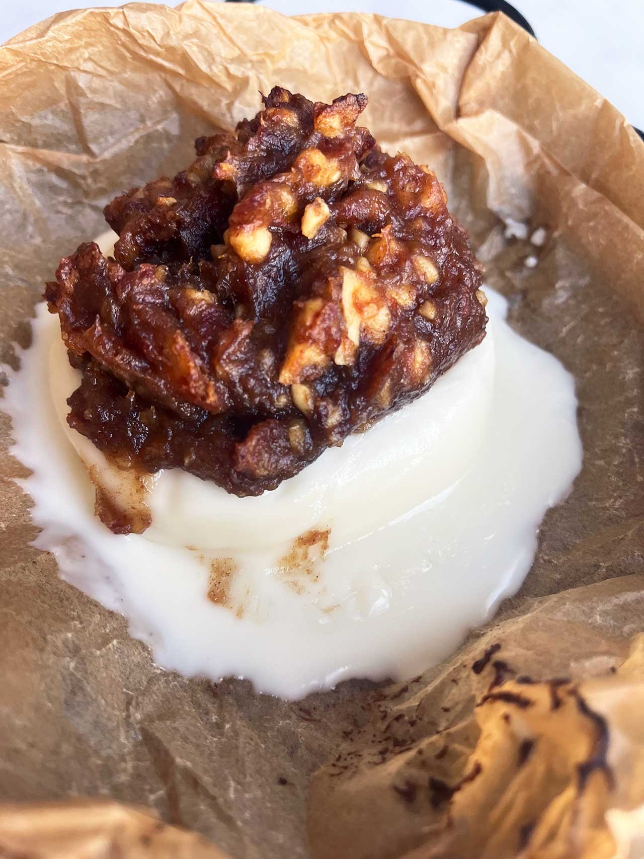 A melty baked brie round in parchment.