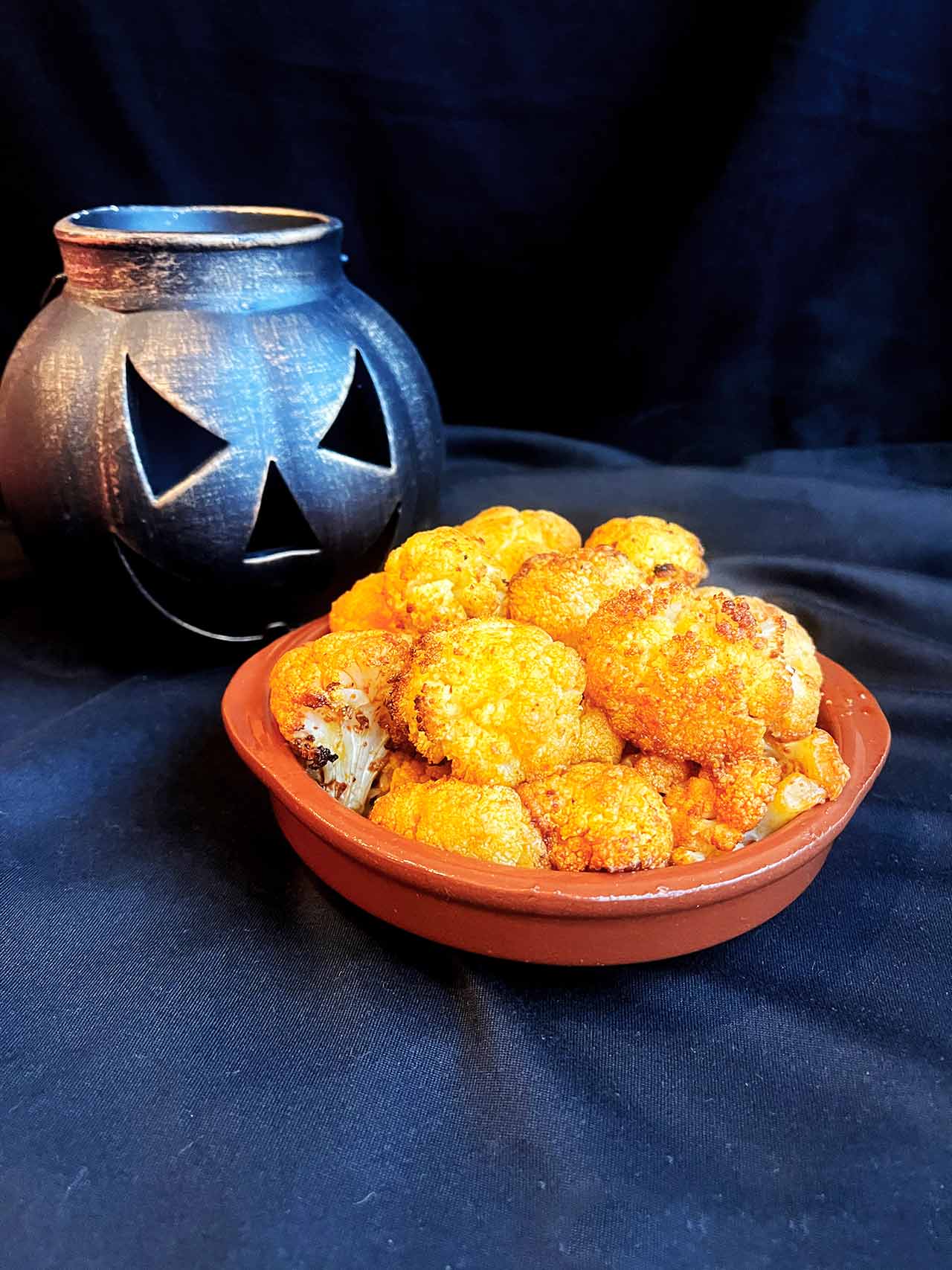 Front view of Roasted Cauliflower Brains served on a brown platter.