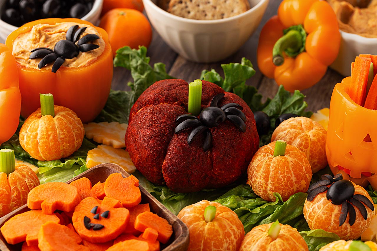 Closeup front focus. A Halloween Charcuterie Board with a pumpkin theme.