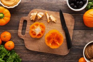 The insides of an orange bell pepper cleaned out to make room in the pepper for dip.