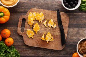 Cutting the sides of cheese slices to form leaves.