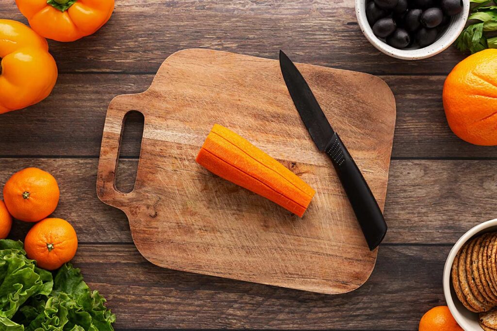 Cuts in a carrot to shape it into a pumpkin when sliced.