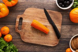 Cuts in a carrot to shape it into a pumpkin when sliced.