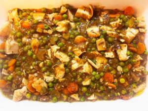 Chicken cobbler filling transferred to a casserole dish.