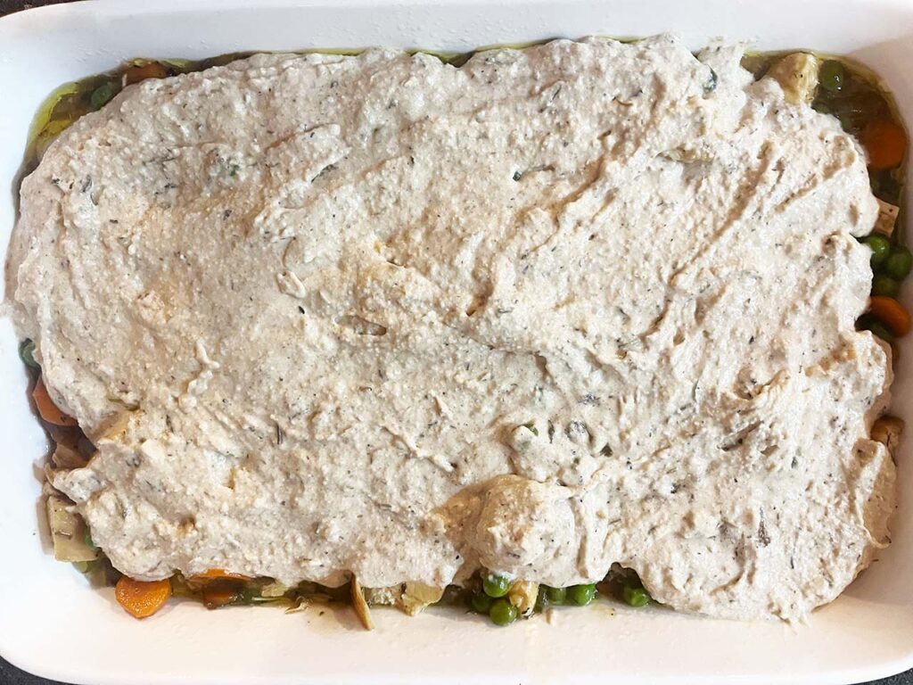 The oat flour topping spread over the filling in a casserole dish.