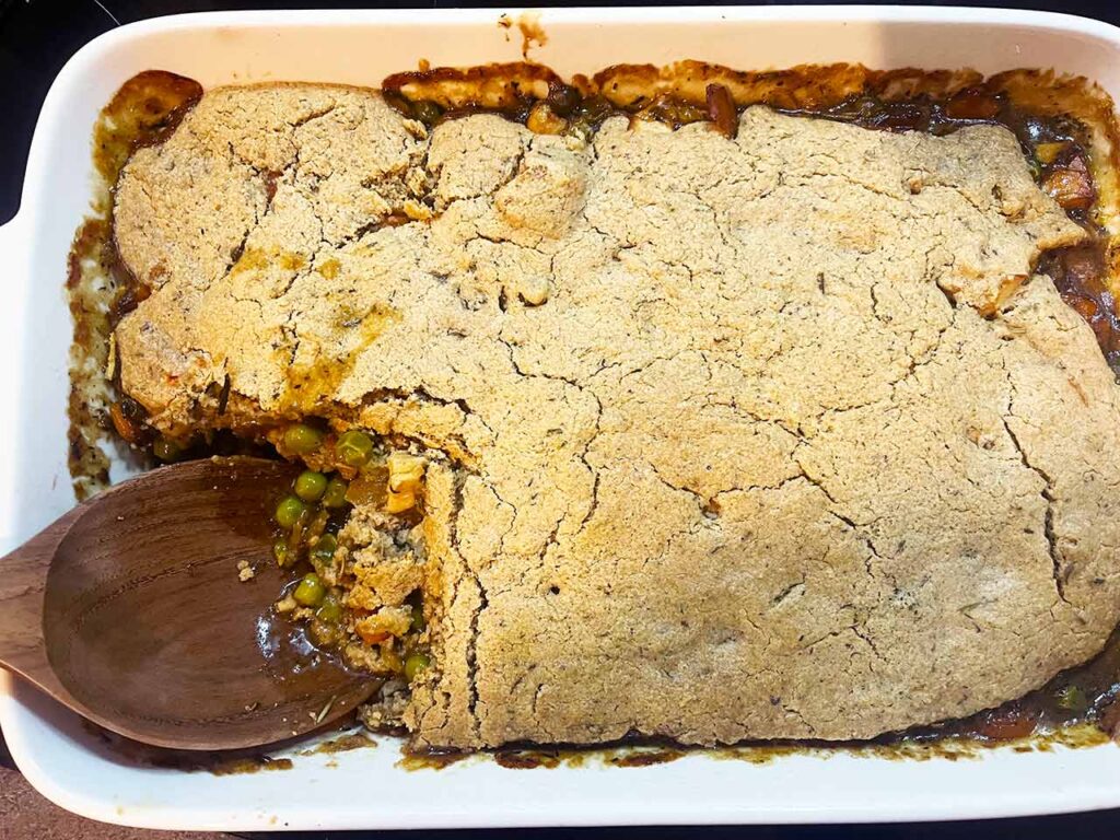 A portion of the casserole missing from the casserole dish..